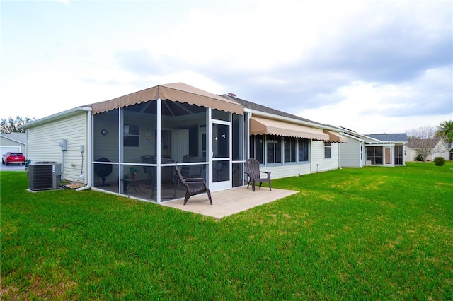 rear view of property with a yard, a sunroom, a patio, and central air condition unit