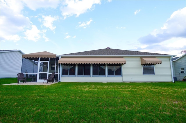 back of house with a patio, a sunroom, and a lawn