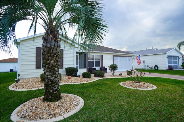 single story home with a garage and a front lawn