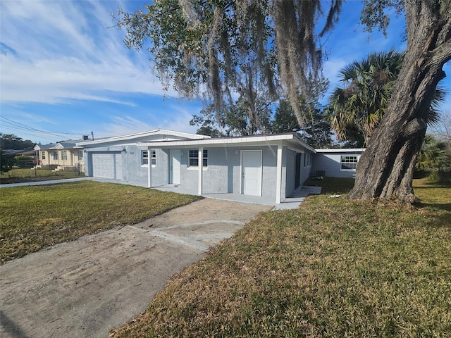 ranch-style home with a garage and a front lawn