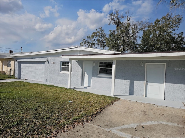 single story home with a garage and a front yard