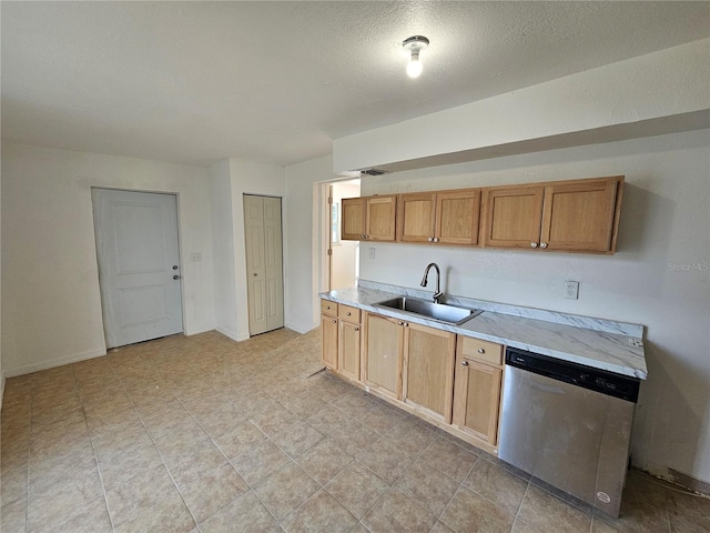 kitchen featuring sink, stainless steel dishwasher, and a textured ceiling