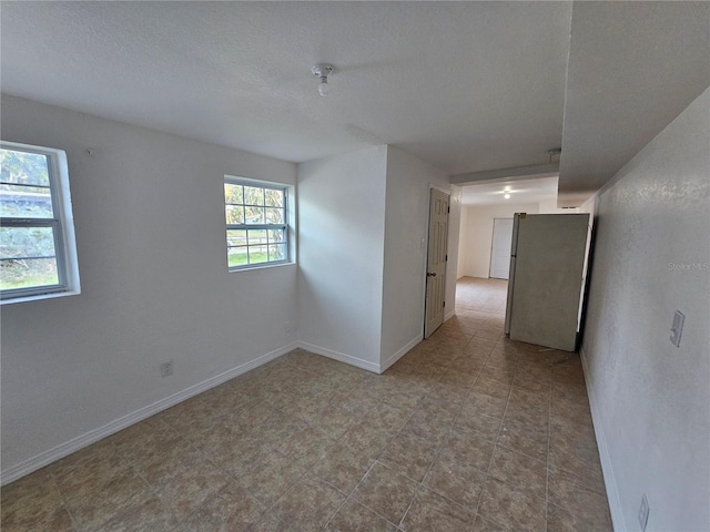 spare room featuring a textured ceiling