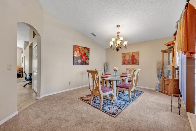 4078 Waltham Forest Dr, Tavares, FL 32778 - dining room featuring light carpet, a textured ceiling, lofted ceiling, and a chandelier