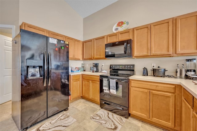 4078 Waltham Forest Dr, Tavares, FL 32778 - kitchen featuring vaulted ceiling, light tile patterned floors, a textured ceiling, and black appliances
