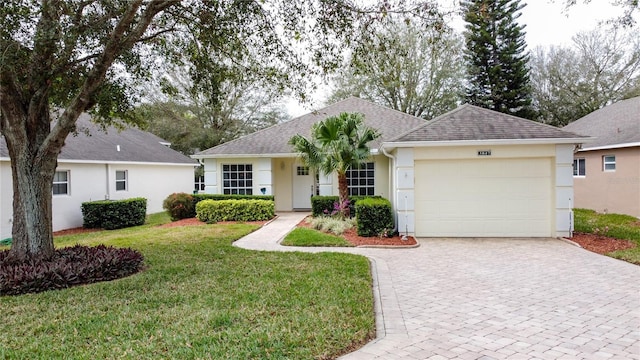 single story home with decorative driveway, stucco siding, a shingled roof, an attached garage, and a front yard