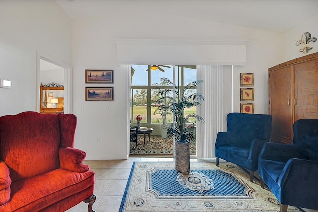 sitting room with light tile patterned flooring, ceiling fan, and lofted ceiling