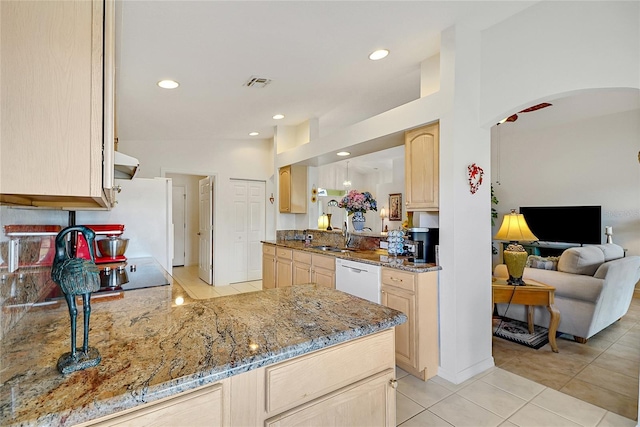 kitchen featuring dishwasher, light stone countertops, light brown cabinets, and light tile patterned flooring