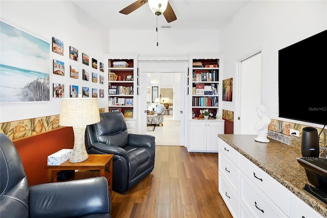 sitting room featuring ceiling fan and hardwood / wood-style floors