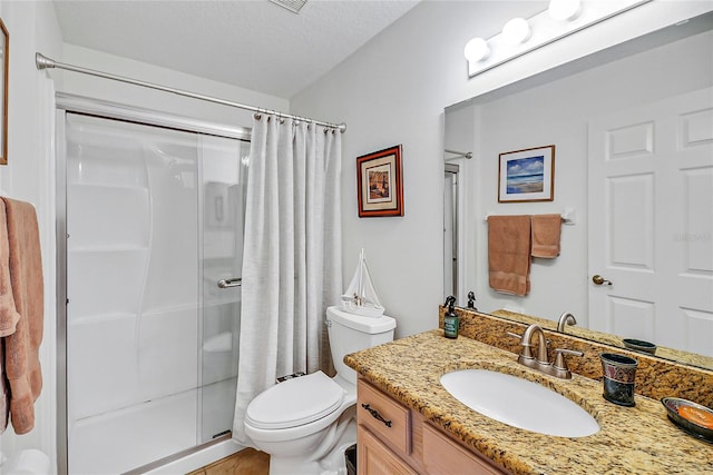 bathroom featuring vanity, toilet, a textured ceiling, and a shower