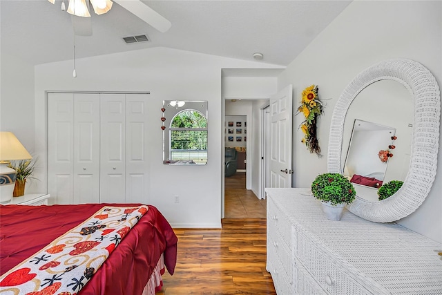 bedroom featuring ceiling fan, a closet, lofted ceiling, and wood-type flooring