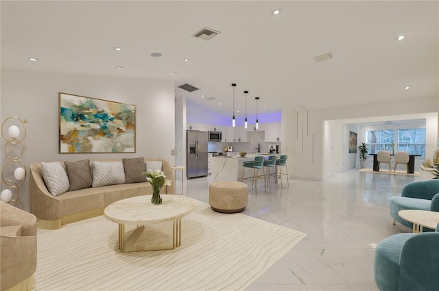 living area featuring recessed lighting, visible vents, and marble finish floor