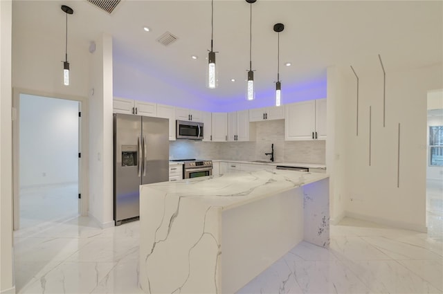 kitchen featuring marble finish floor, appliances with stainless steel finishes, white cabinets, and a sink