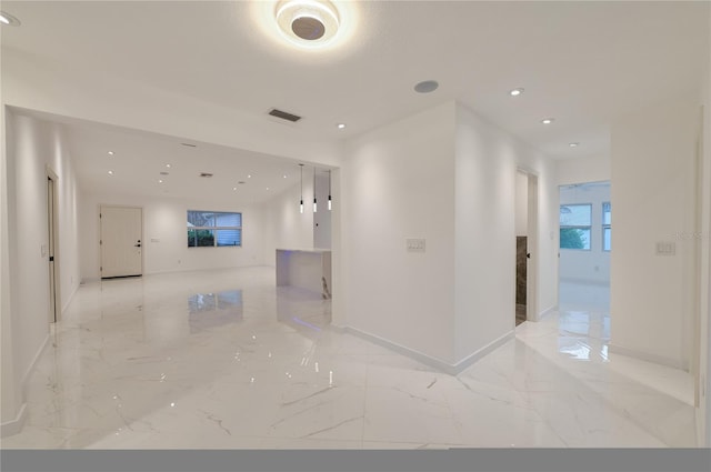 hallway featuring recessed lighting, visible vents, marble finish floor, and baseboards