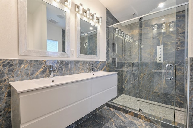 bathroom featuring a shower stall, double vanity, visible vents, and a sink