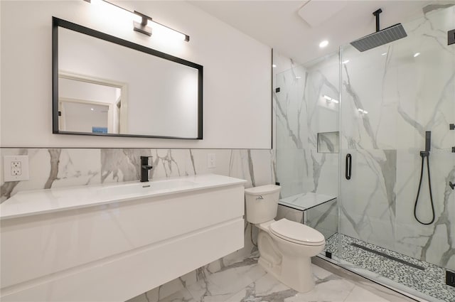 bathroom featuring toilet, marble finish floor, recessed lighting, a marble finish shower, and vanity