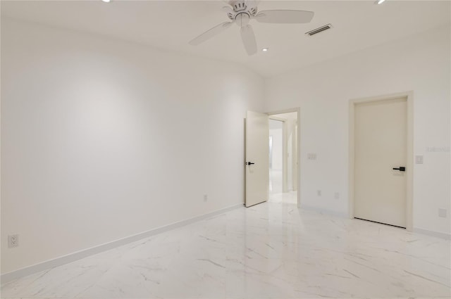 unfurnished room featuring visible vents, baseboards, marble finish floor, and a ceiling fan