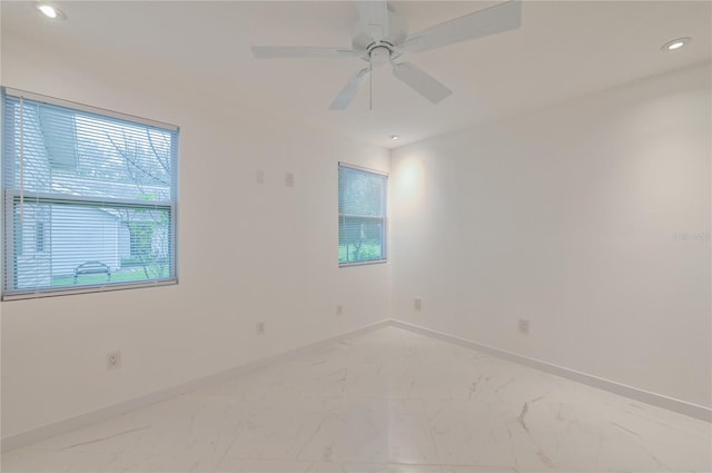 spare room with recessed lighting, baseboards, marble finish floor, and ceiling fan