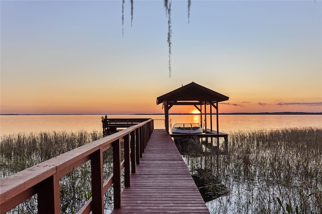 dock area with a water view and boat lift