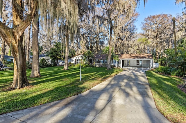 single story home featuring concrete driveway and a front yard