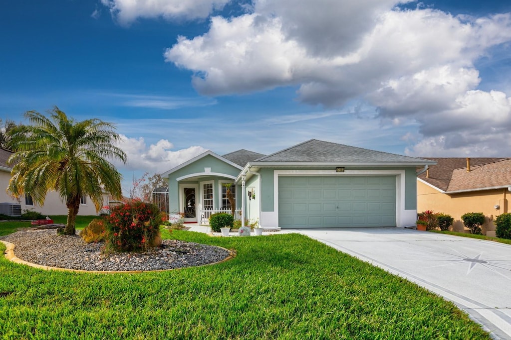 ranch-style home with a garage and a front lawn