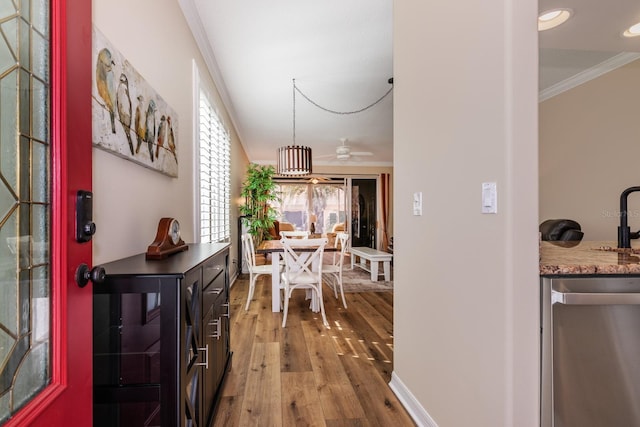 interior space featuring crown molding and light hardwood / wood-style flooring