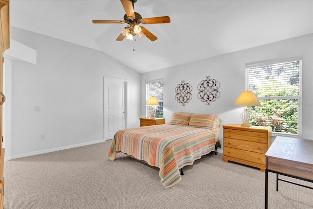 carpeted bedroom featuring multiple windows, lofted ceiling, and ceiling fan