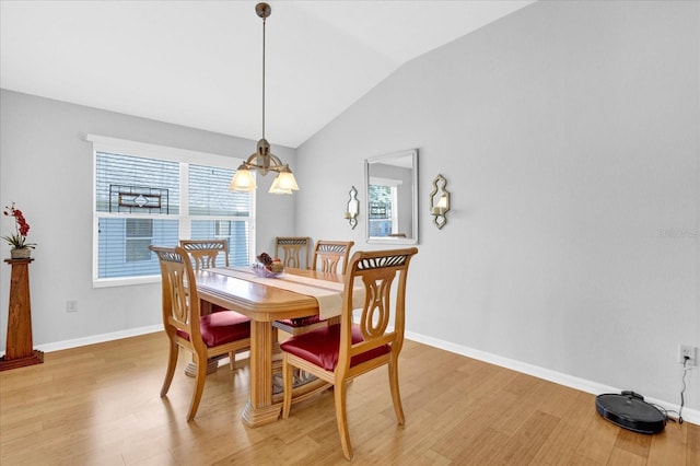 dining room featuring lofted ceiling and light wood-type flooring