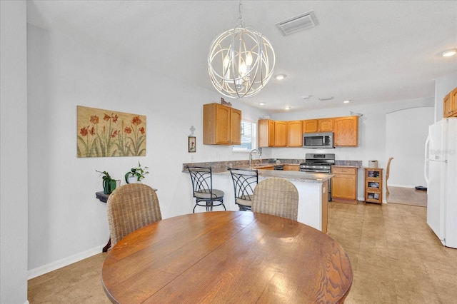 dining room with sink and a notable chandelier