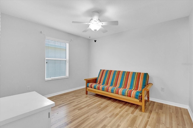 living area with ceiling fan and light hardwood / wood-style floors