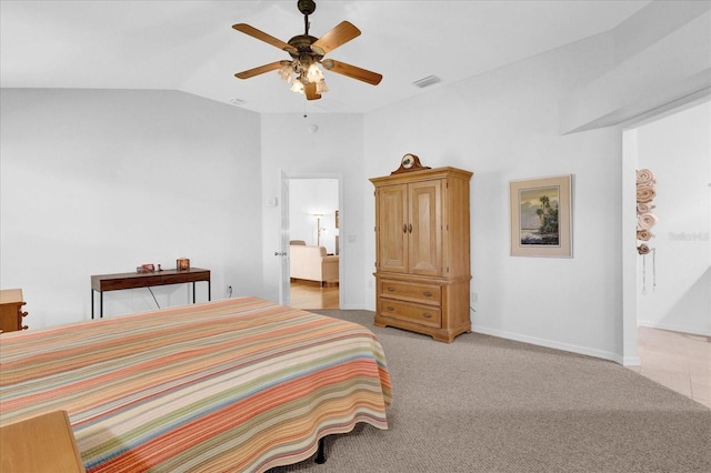 bedroom featuring vaulted ceiling, light colored carpet, and ceiling fan