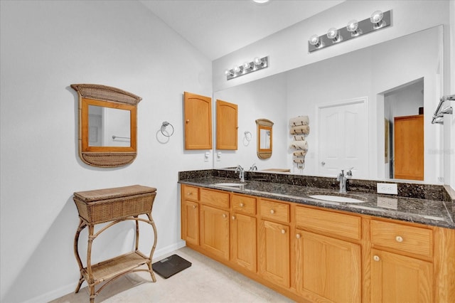 bathroom featuring vanity and lofted ceiling