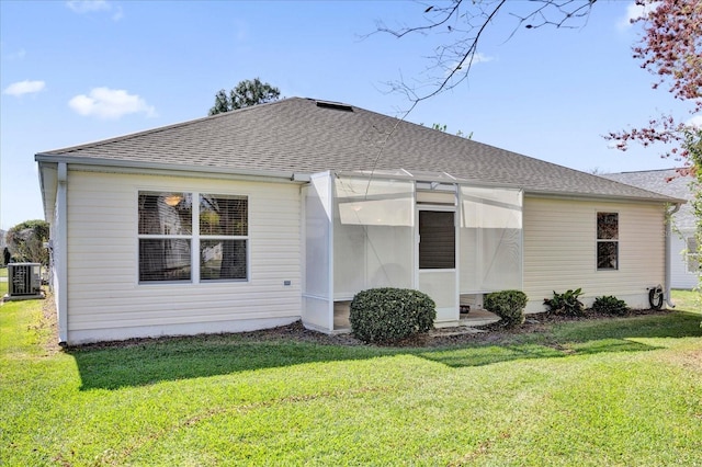 exterior space featuring central AC and a front lawn