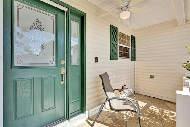 doorway to property featuring ceiling fan