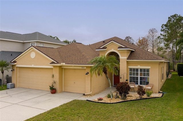 view of front of property featuring an attached garage, a front yard, and stucco siding