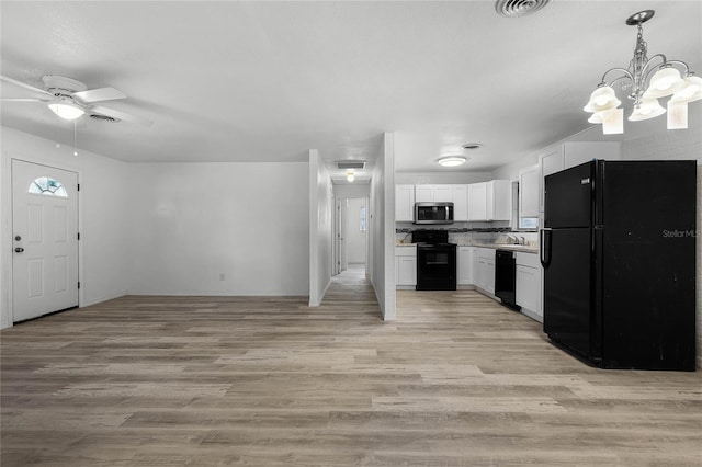 kitchen featuring a sink, visible vents, white cabinets, light wood-type flooring, and black appliances