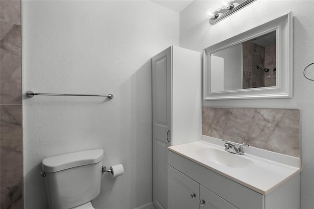 full bathroom with toilet and vanity