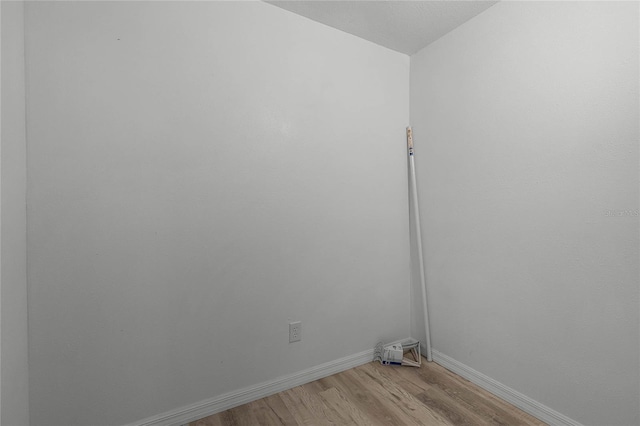 unfurnished room with light wood finished floors and baseboards