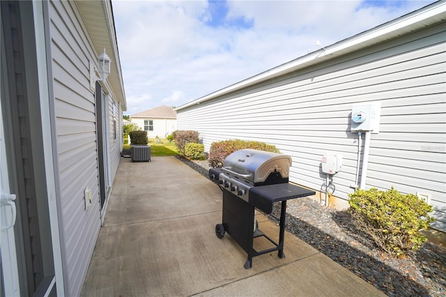 view of patio with area for grilling and central AC unit