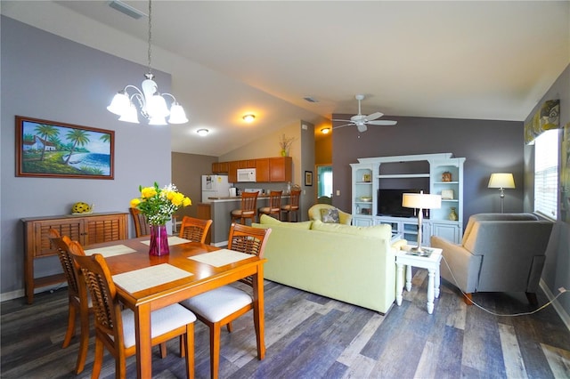 dining area with lofted ceiling, hardwood / wood-style floors, ceiling fan with notable chandelier, and a healthy amount of sunlight