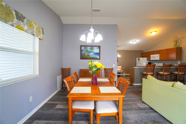 dining space featuring vaulted ceiling, an inviting chandelier, and dark hardwood / wood-style flooring