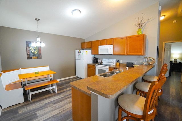 kitchen featuring a kitchen bar, sink, kitchen peninsula, pendant lighting, and white appliances