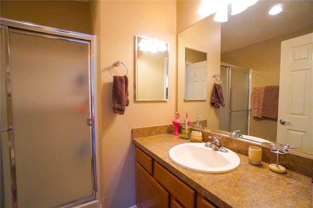 bathroom with vanity and a shower with shower door