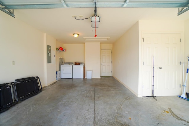 garage with electric panel and washing machine and dryer