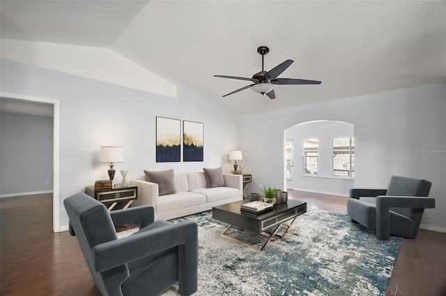 living area with lofted ceiling, ceiling fan, baseboards, and wood finished floors