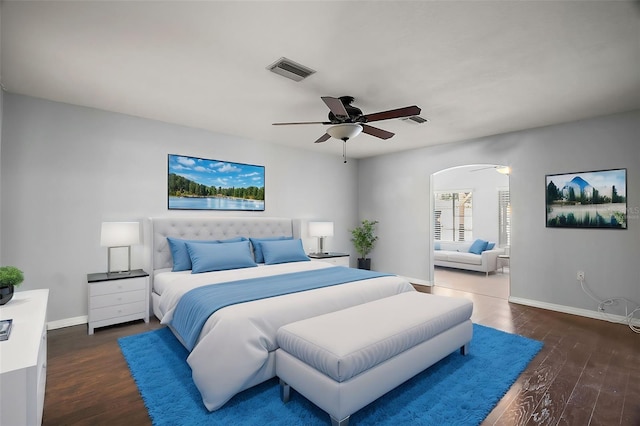 bedroom featuring visible vents, baseboards, and wood finished floors