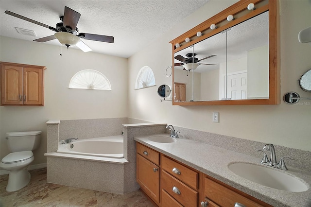 full bath featuring toilet, a garden tub, a textured ceiling, and a sink