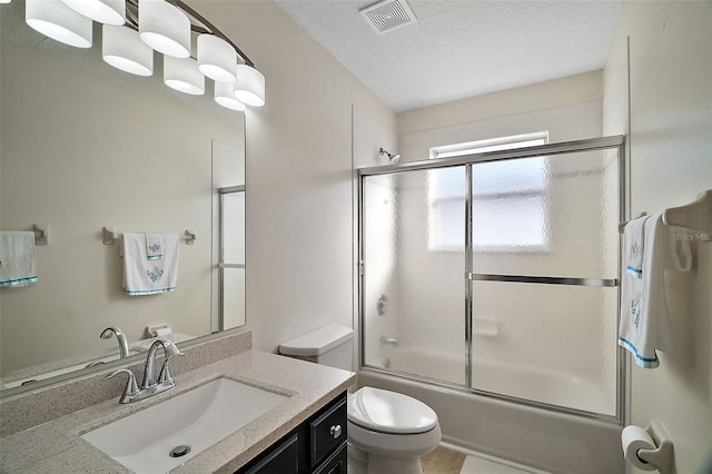 bathroom with shower / bath combination with glass door, visible vents, toilet, a textured ceiling, and vanity