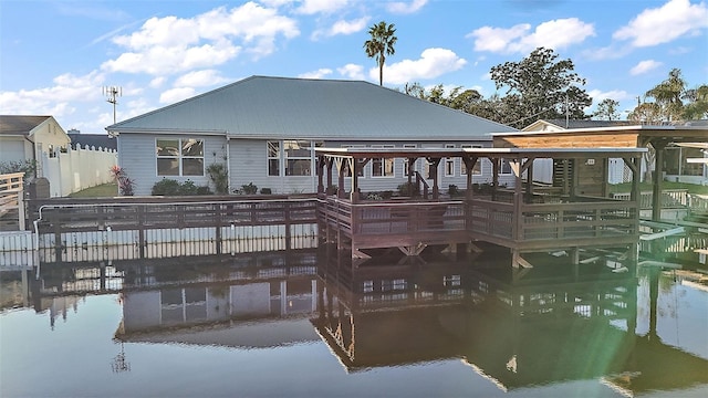 back of property featuring metal roof