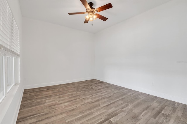 spare room featuring hardwood / wood-style flooring and ceiling fan